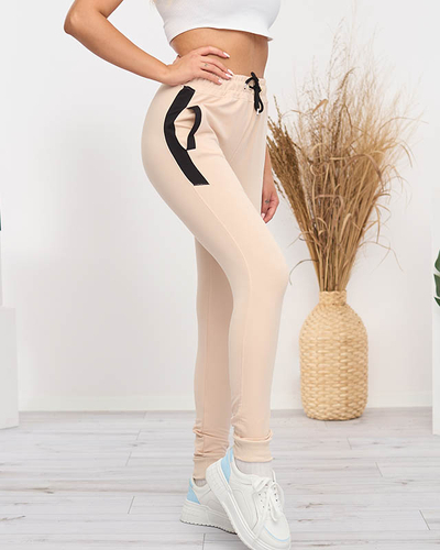 Royalfashion Beżowe damskie spodnie dresowe z czarnymi wstawkami