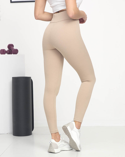 Royalfashion Jasnobrązowe damskie prążkowane legginsy z pomarańczowymi napisami