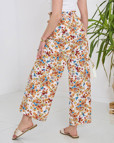 Royalfashion Damskie białe spodnie typu palazzo w pomarańczowe kwiaty