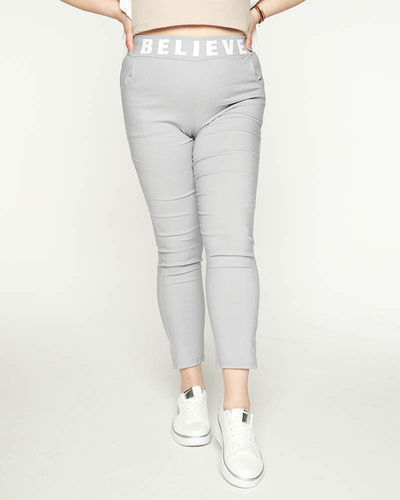 Royalfashion Szare damskie spodnie materiałowe z napisem PLUS SIZE