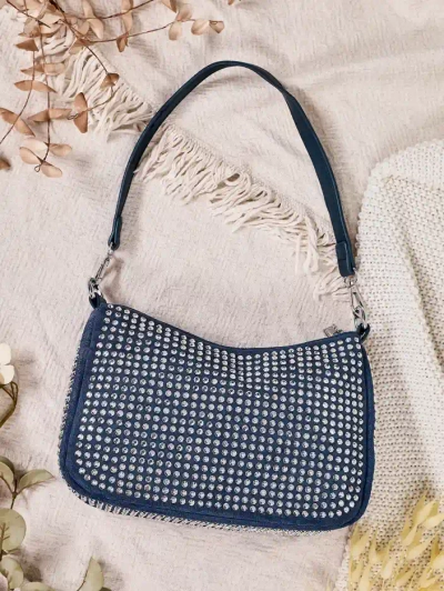 Royalfashion Mala ženska torbica s žebljički